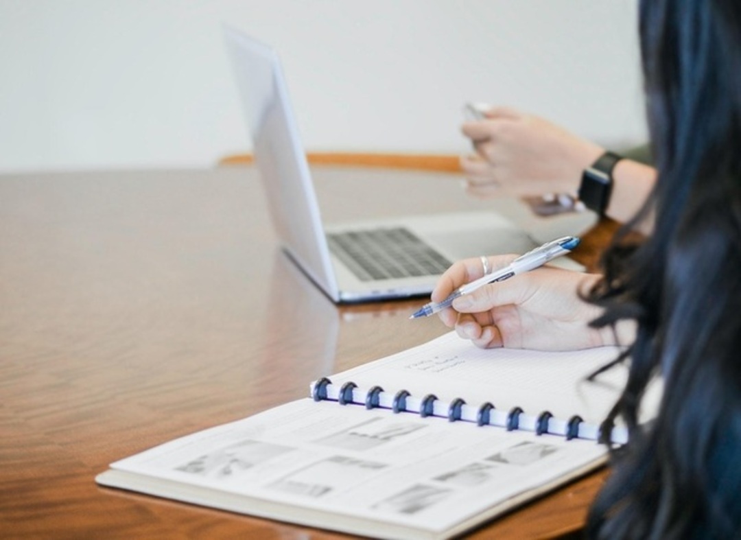 A picture of a person writing down their business strategy with Double Iron Consulting.