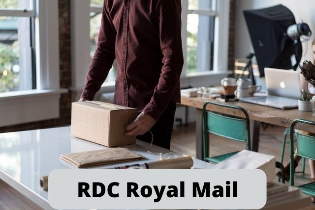 A White man placing RDC Royal Mail box on the table