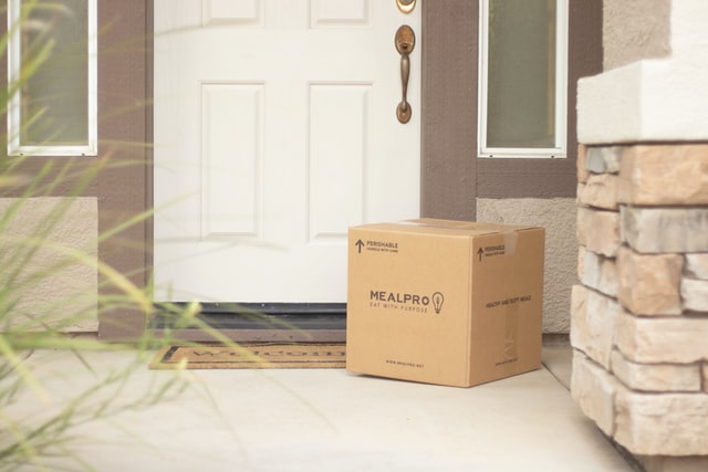 A delivery box in front of a house door